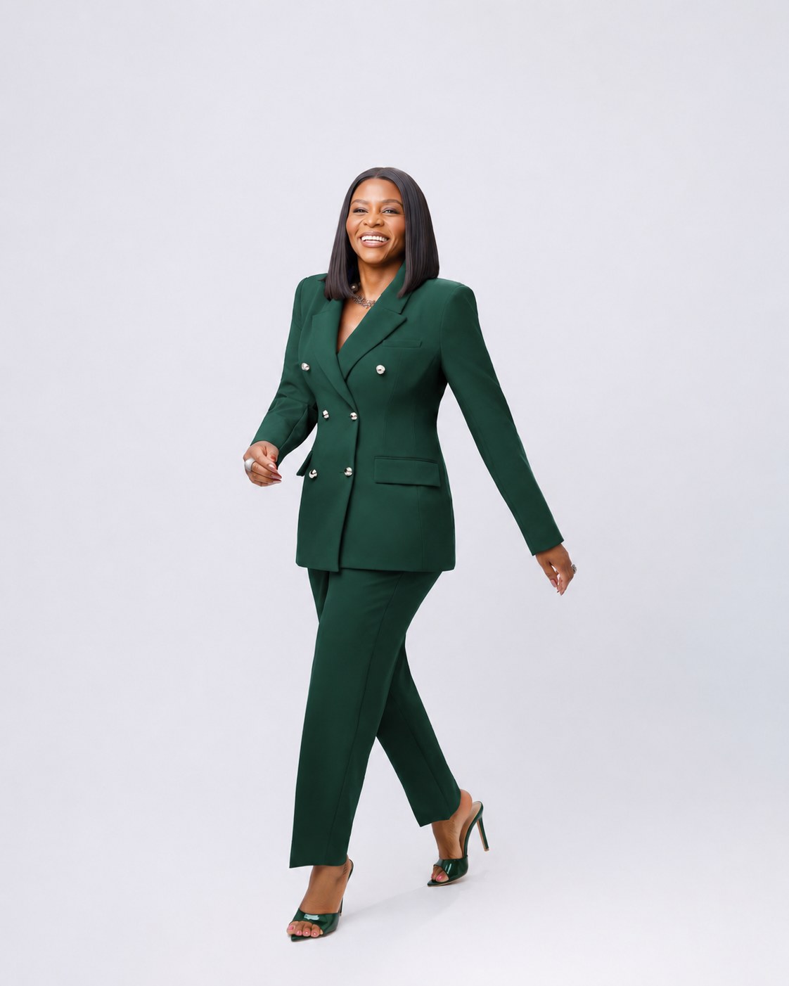 The founder of Victoria L Events in a deep green suit